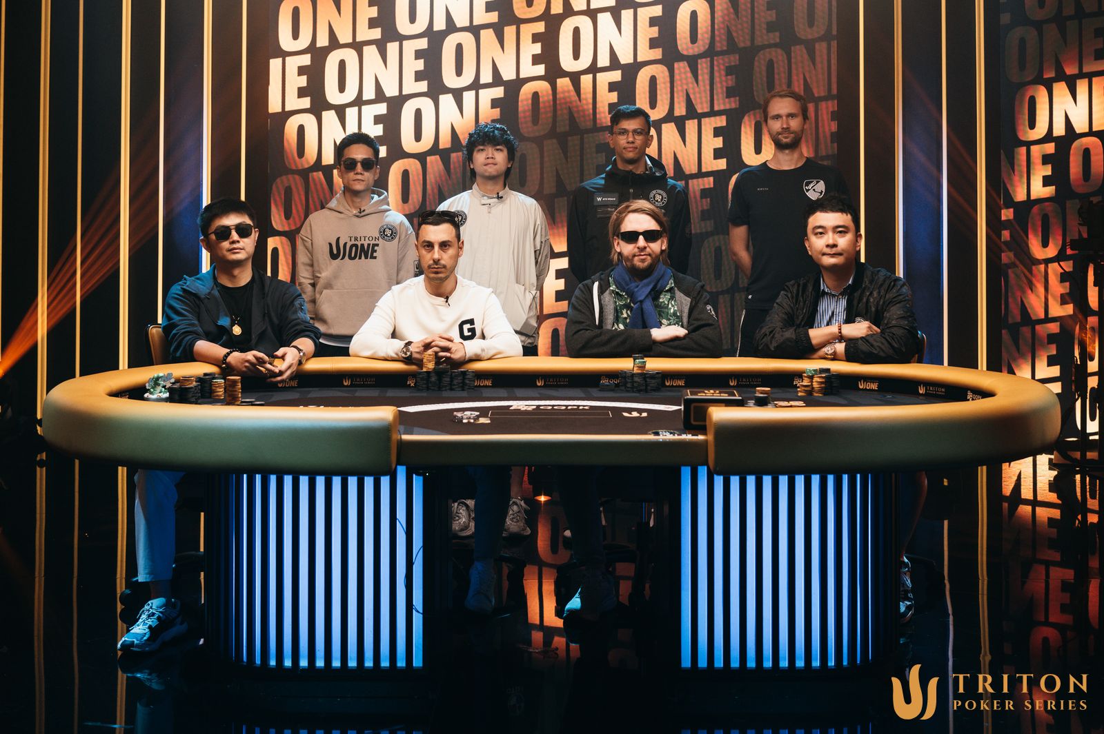 QQPK Genesis final table players (clockwise from back left): Chengxu Hu, Po Sen Wang, Samuel Mullur, Niklas Deitmer, Wang Sum Li, Martin Nielsen, Aren Bezhanyan, Cheng Huang.