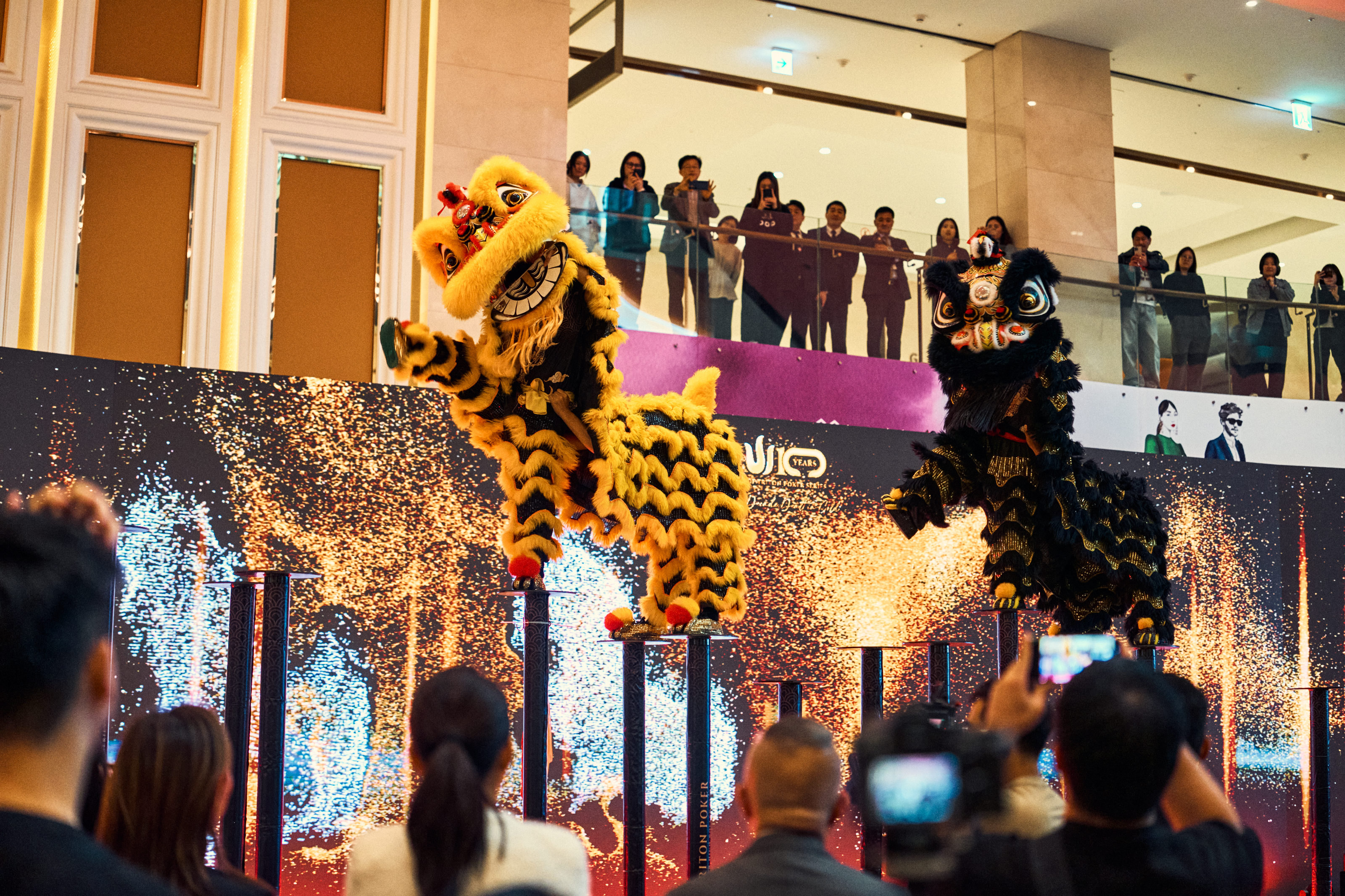 Twin lion dancers perform with sparks flying as Triton celebrates at LES A Casino, Jeju